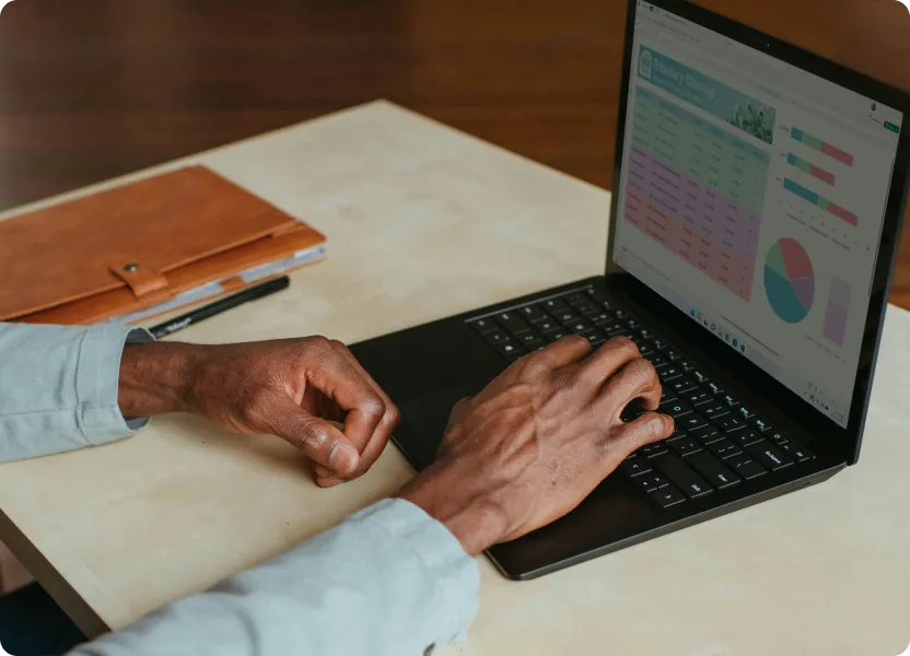 Professional managing tasks on a laptop in a home office