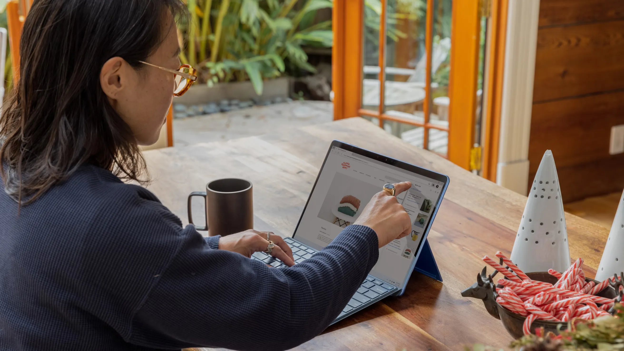Designer sketching on a tablet in a bright workspace